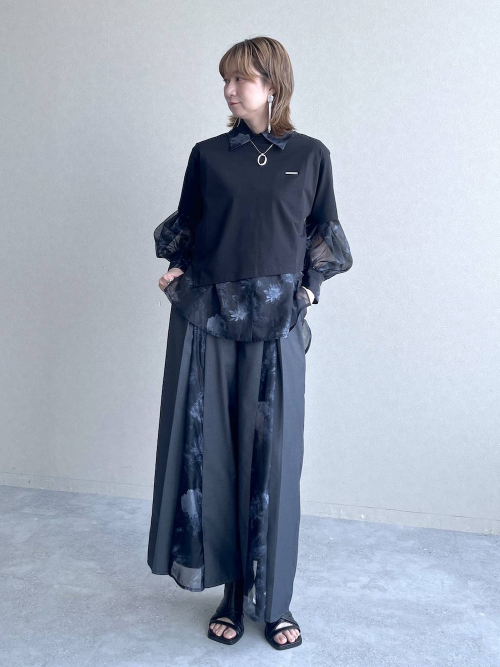 ブラック系のTシャツ/カットソー、ブラック系のサンダル、ブラック系のシャツ/ブラウスを着用したレディースの春コーディネートの2枚目の写真