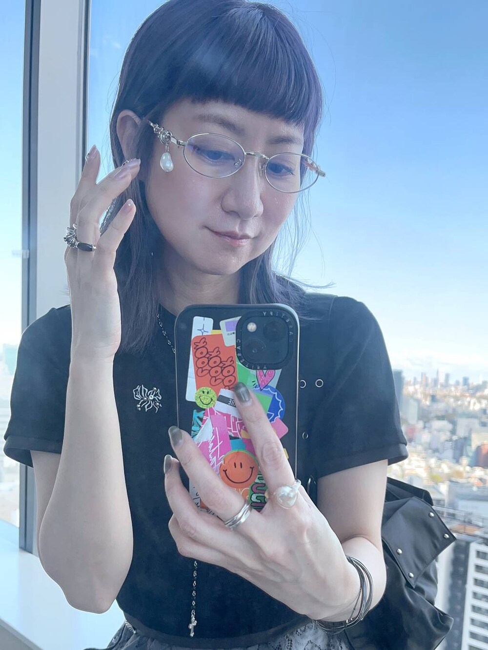 ブラック系のTシャツ/カットソー、ブラック系のネックレス、シルバー系のメガネを着用したレディースの春コーディネートの4枚目の写真