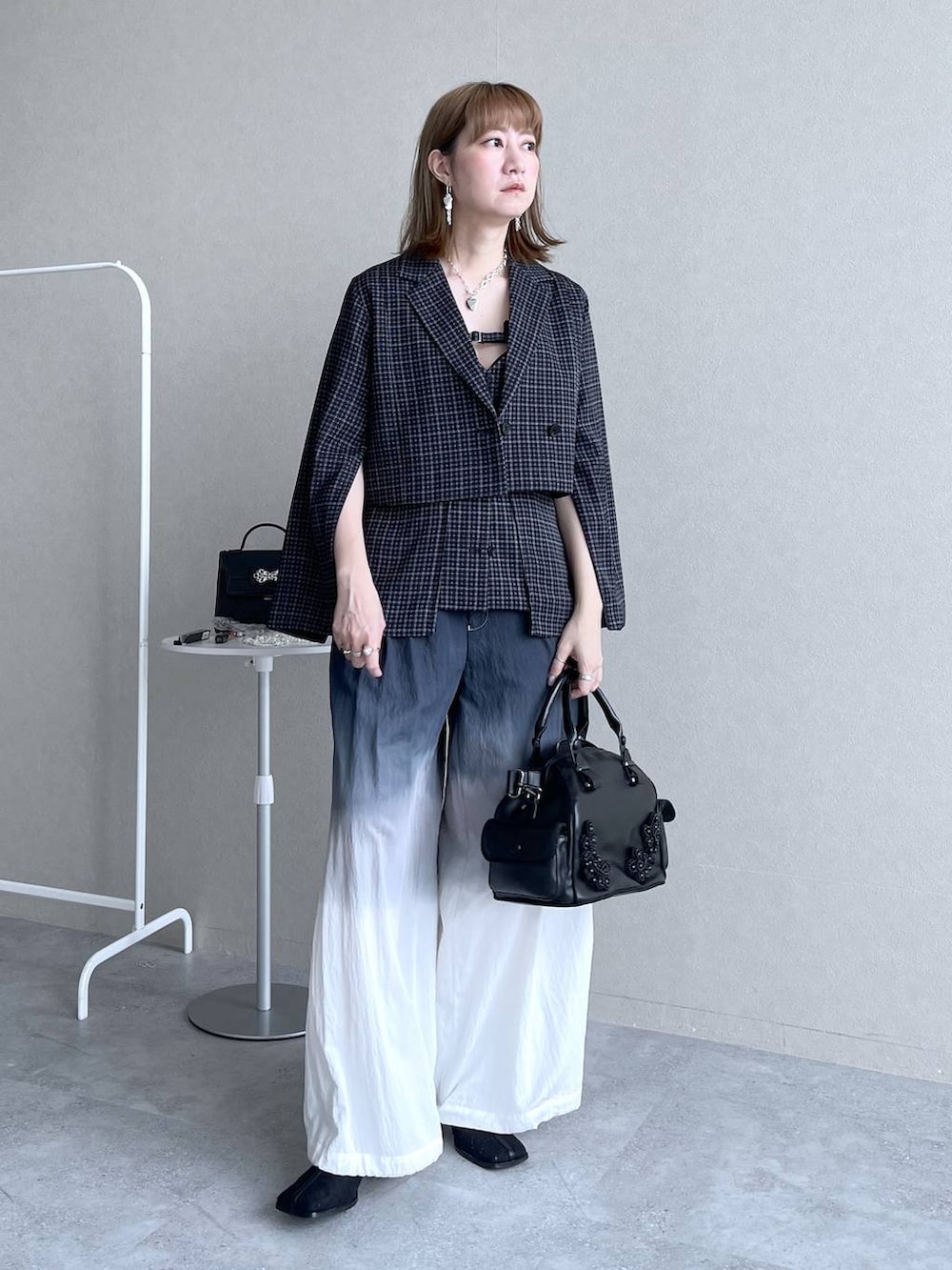 ブラック系のブーツ、ブラック系のボストンバッグ、ブラック系のその他パンツを着用したレディースの冬コーディネートの9枚目の写真