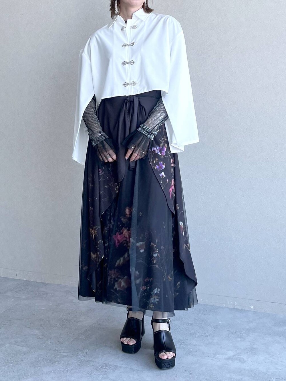 ブラック系のスカート、ブラック系のTシャツ/カットソー、ホワイト系のシャツ/ブラウスを着用したレディースの春コーディネートの4枚目の写真