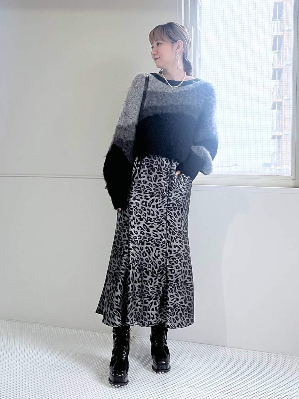 ブラック系のブーツ、ブラック系のショルダーバッグ、ブラック系のニット/セーターを着用したレディースの秋コーディネートの9枚目の写真