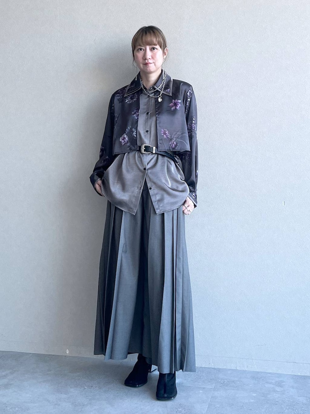 グレー系のスラックス、ブラック系のブーツ、グレー系のシャツ/ブラウスを着用したレディースの冬コーディネートの4枚目の写真