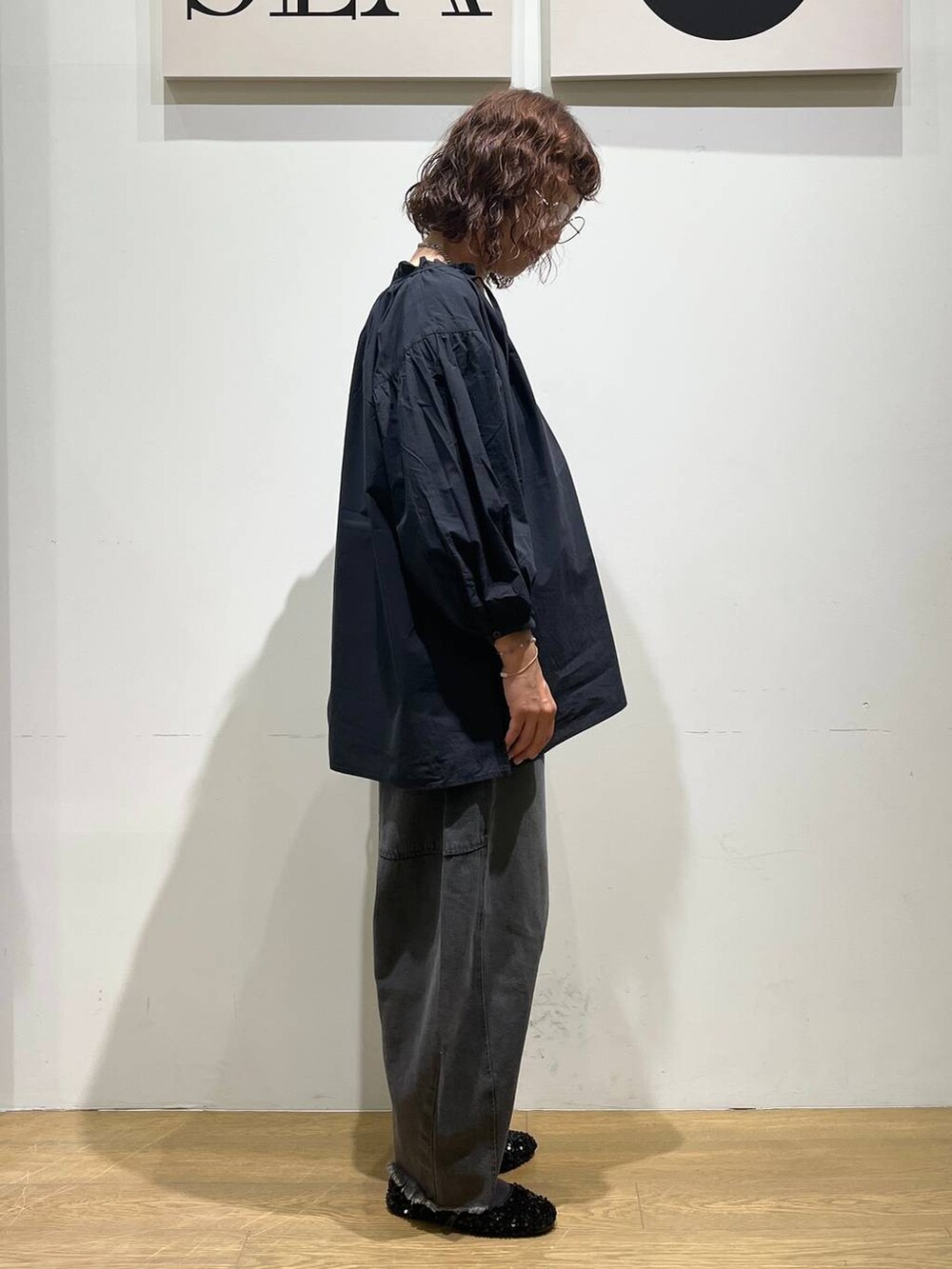 ブラック系のデニムパンツ、ブラック系のシャツ/ブラウス、シルバー系のショルダーバッグを着用したレディースの秋コーディネートの4枚目の写真