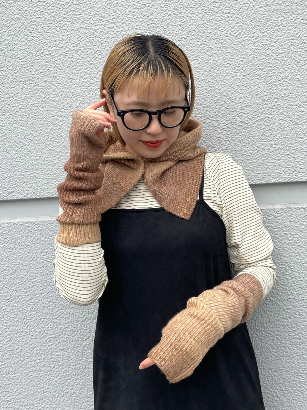 ブラック系のワンピース、グリーン系のTシャツ/カットソー、ブラウン系の手袋を着用したレディースの秋コーディネートの2枚目の写真