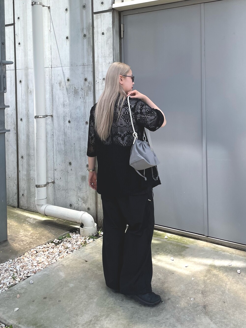 ブラック系のテーラードジャケット、グレー系のバッグ、ブラック系のサロペット/オーバーオールを着用したレディースの夏コーディネートの5枚目の写真