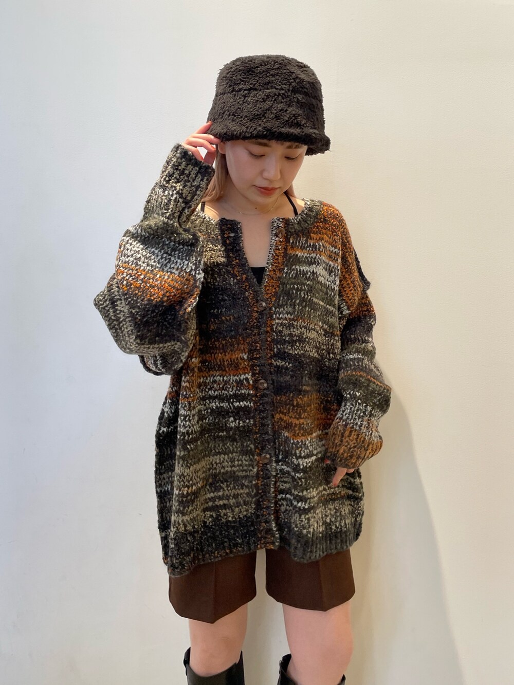 グリーン系のカーディガン/ボレロ、ブラウン系のその他パンツ、ブラック系のブーツを着用したレディースの秋コーディネートの4枚目の写真