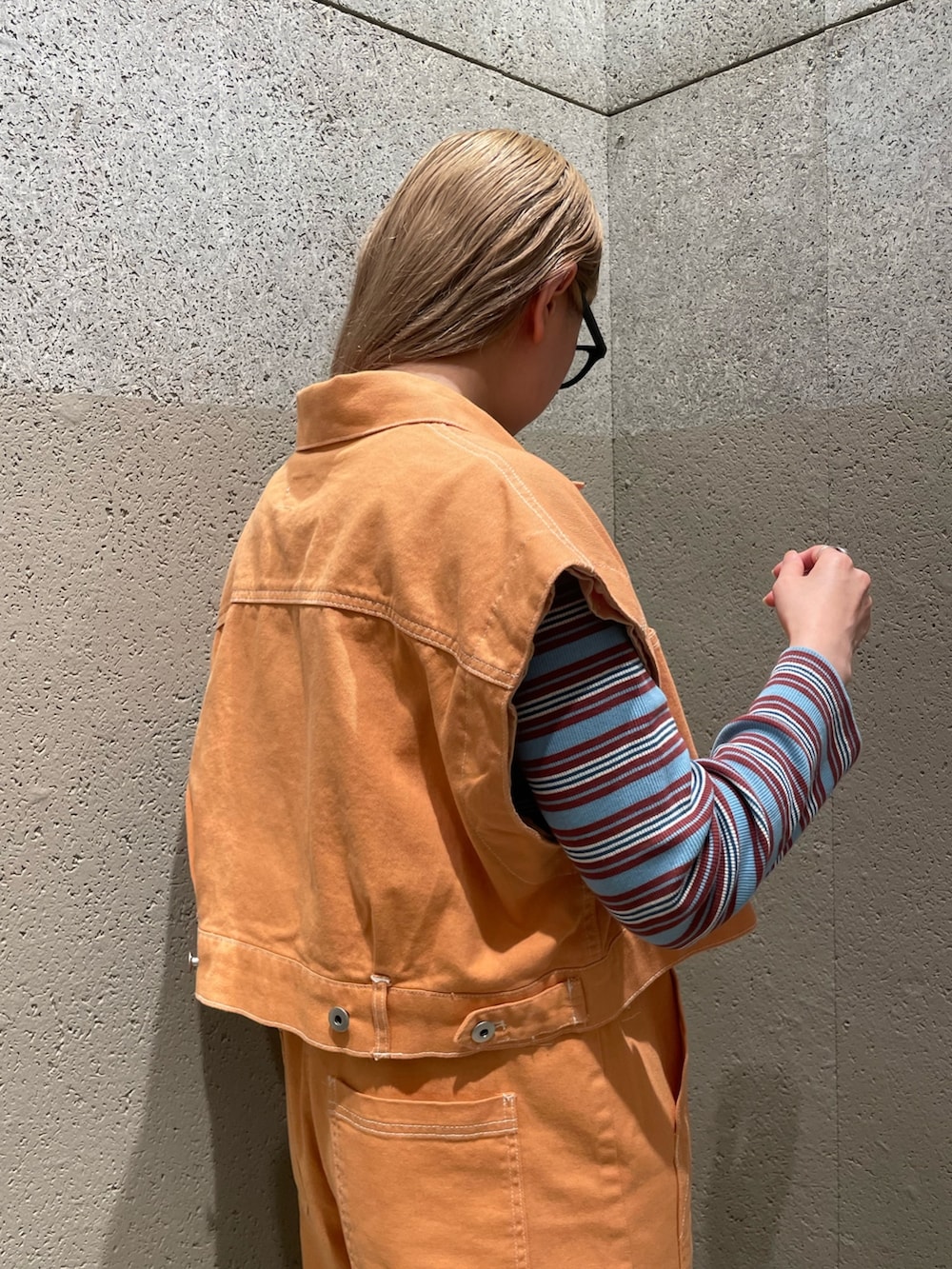 オレンジ系のデニムジャケット、オレンジ系のサロペット/オーバーオール、ブルー系のワンピースを着用したレディースの秋コーディネートの3枚目の写真