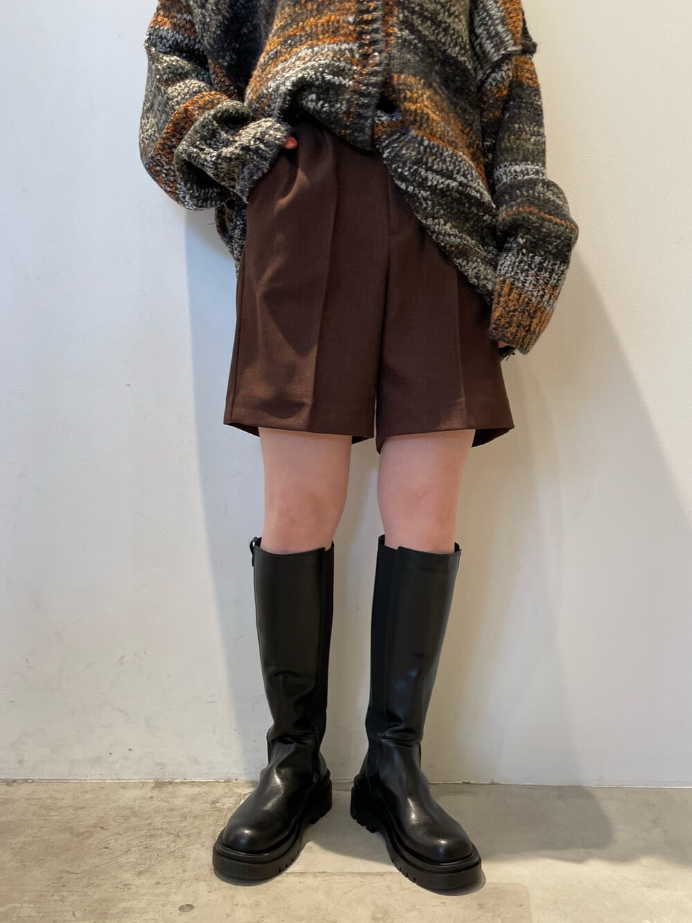 グリーン系のカーディガン/ボレロ、ブラウン系のその他パンツ、ブラック系のブーツを着用したレディースの秋コーディネートの7枚目の写真