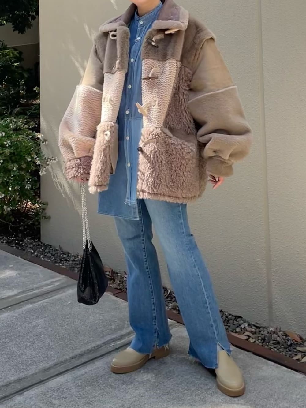 ブラウン系のジャケット/アウター、ブラック系のショルダーバッグ、ブルー系のデニムパンツを着用したレディースの秋コーディネートの3枚目の写真