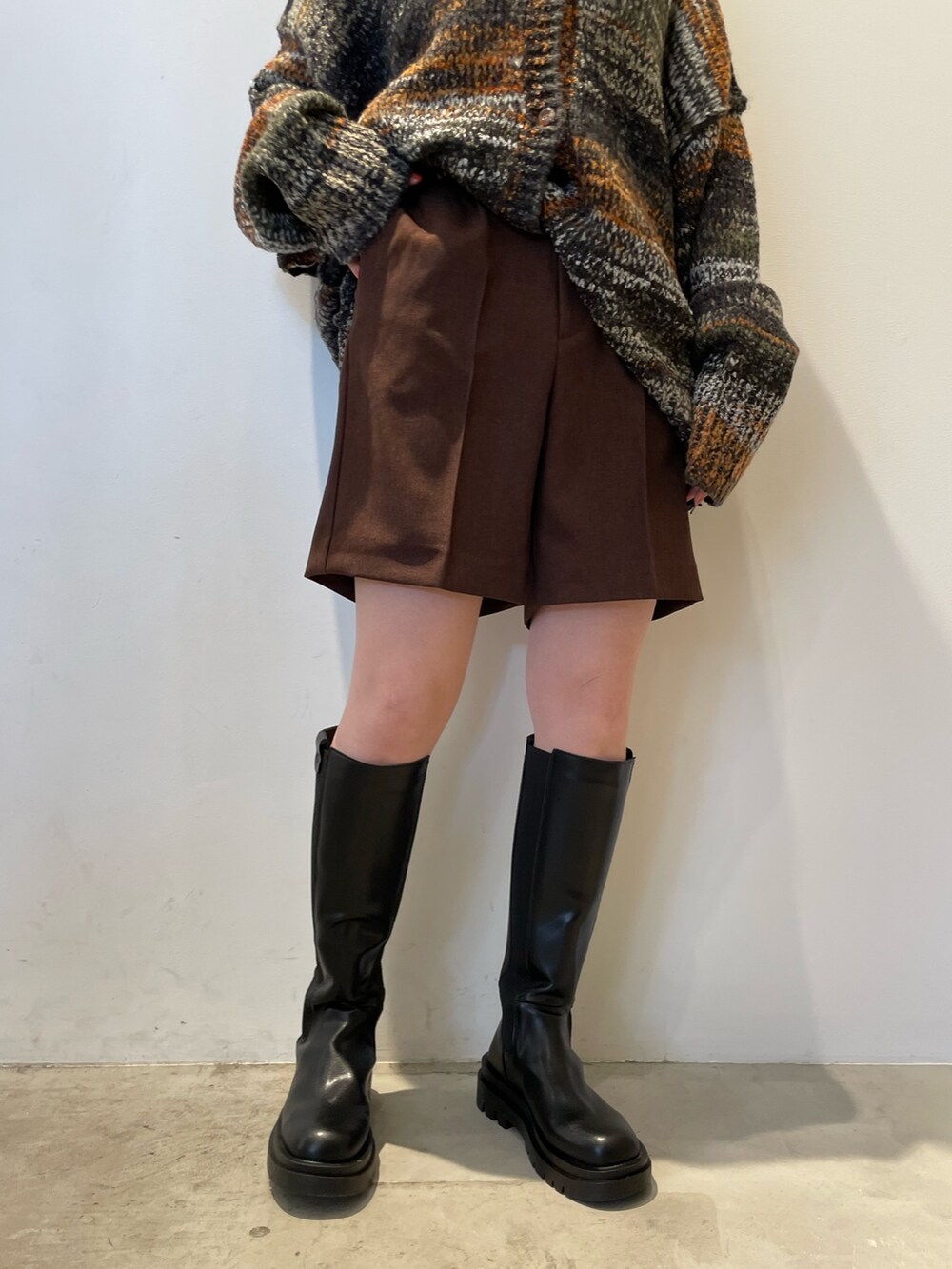 グリーン系のカーディガン/ボレロ、ブラウン系のその他パンツ、ブラック系のブーツを着用したレディースの秋コーディネートの8枚目の写真