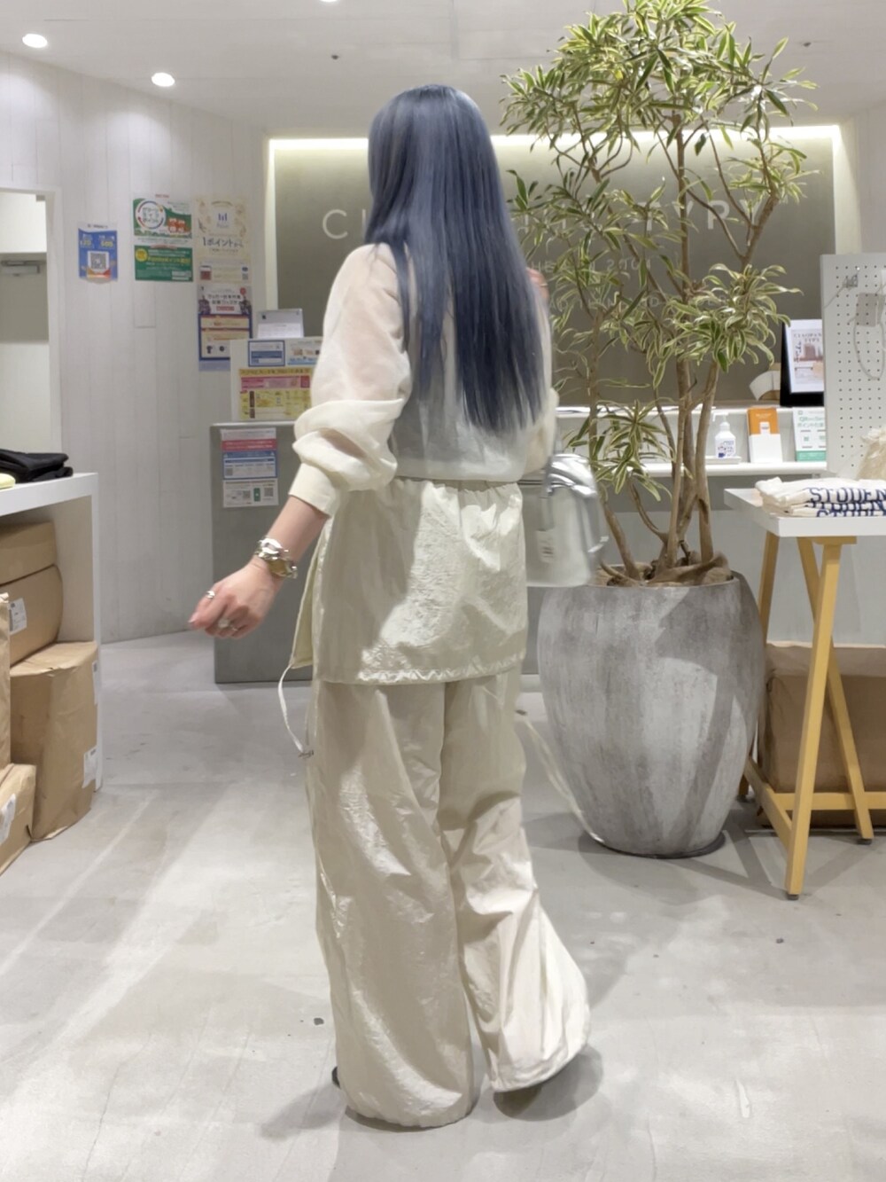 ホワイト系のニット/セーター、ホワイト系のサロペット/オーバーオール、シルバー系のバッグを着用したレディースの春コーディネートの7枚目の写真