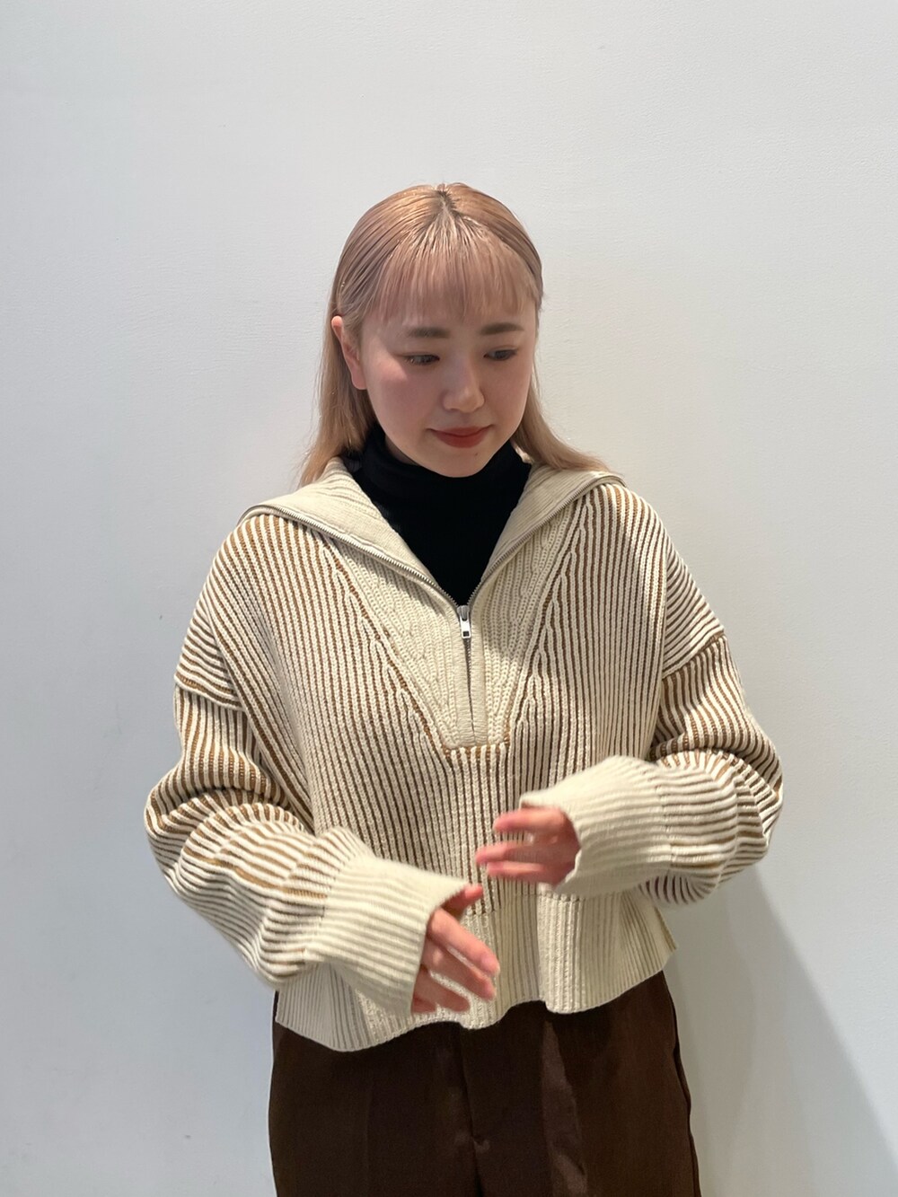 ベージュ系のニット/セーター、ブラウン系のその他パンツ、ブラック系のブーツを着用したレディースの秋コーディネートの4枚目の写真