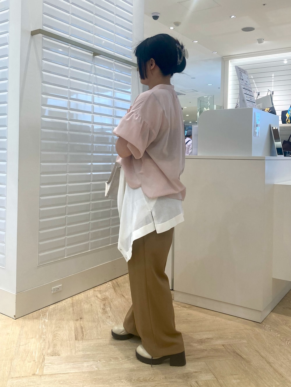 イエロー系のトートバッグ、ホワイト系のカーディガン/ボレロ、ピンク系のシャツ/ブラウスを着用したレディースの春コーディネートの6枚目の写真