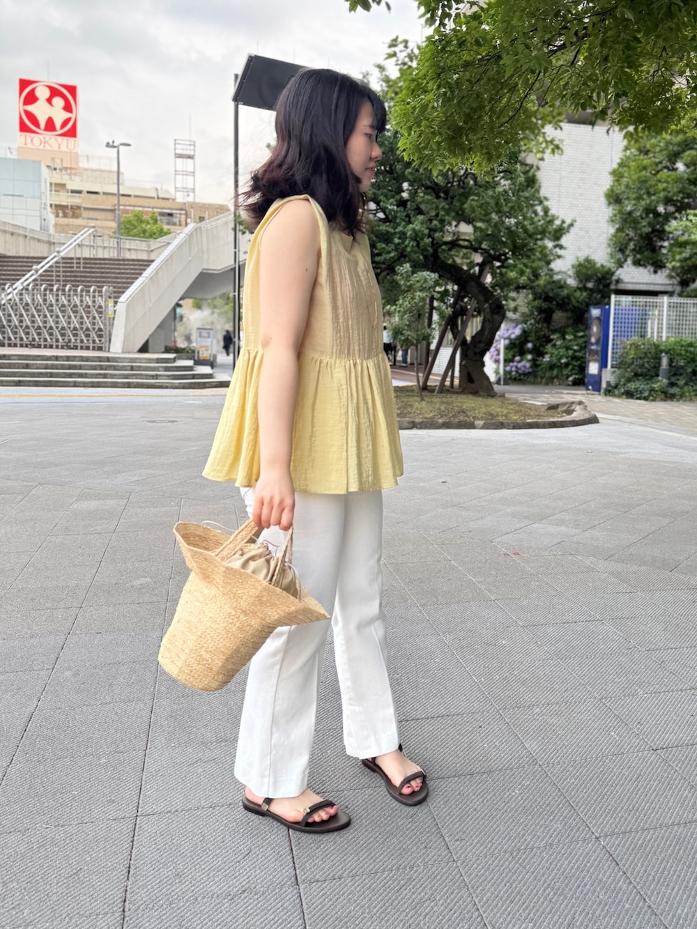 ホワイト系のデニムパンツ、イエロー系のシャツ/ブラウス、ブラウン系のサンダルを着用したレディースの夏コーディネートの2枚目の写真