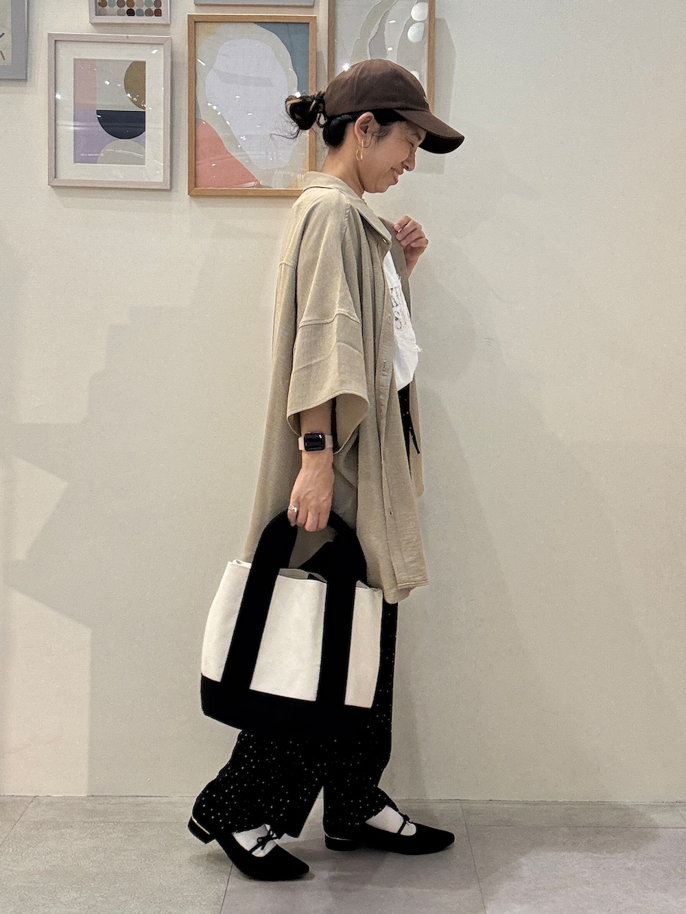 ブラック系のトートバッグ、ベージュ系のシャツ/ブラウス、ブラック系のその他パンツを着用したレディースの春コーディネートの2枚目の写真