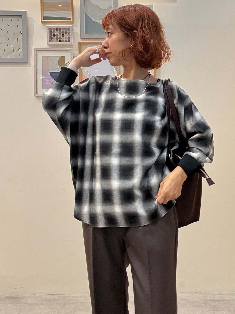 グレー系のシャツ/ブラウス、ブラウン系のその他パンツ、レッド系のトートバッグを着用したレディースの秋コーディネートの4枚目の写真
