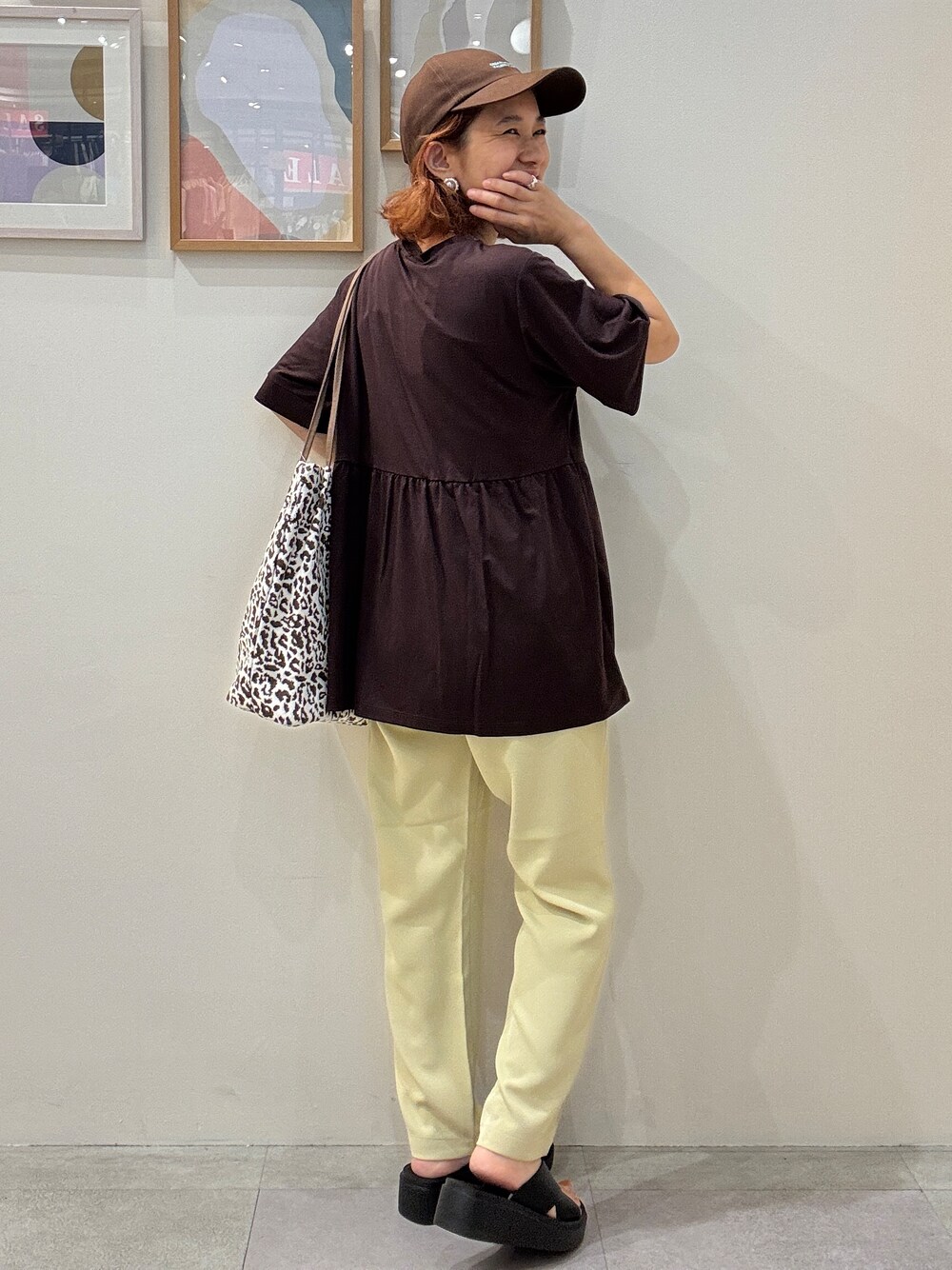 ブラウン系のTシャツ/カットソー、イエロー系のその他パンツ、ブラウン系のトートバッグを着用したレディースの夏コーディネートの3枚目の写真