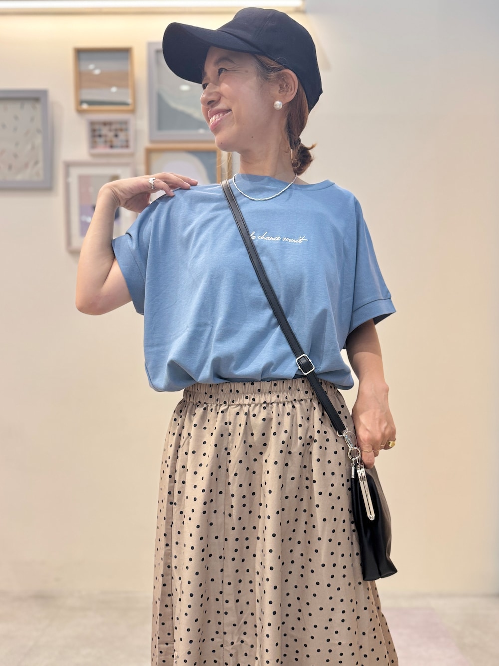 ブルー系のTシャツ/カットソー、ブラウン系のスカート、ブラウン系のサンダルを着用したレディースの夏コーディネートの4枚目の写真