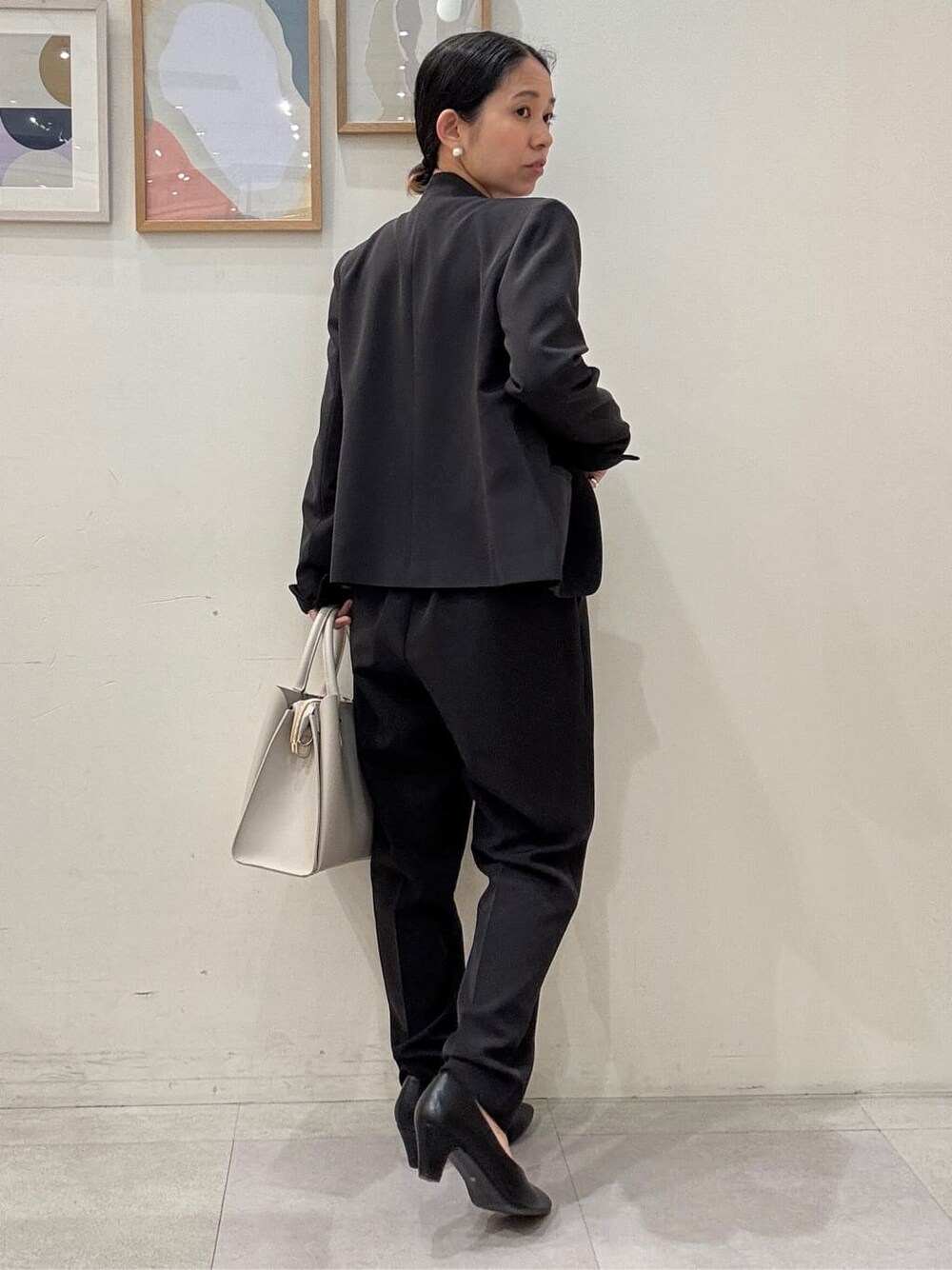ブラック系のノーカラージャケット、ブラック系のパンプス、グレー系のトートバッグを着用したレディースの冬コーディネートの3枚目の写真