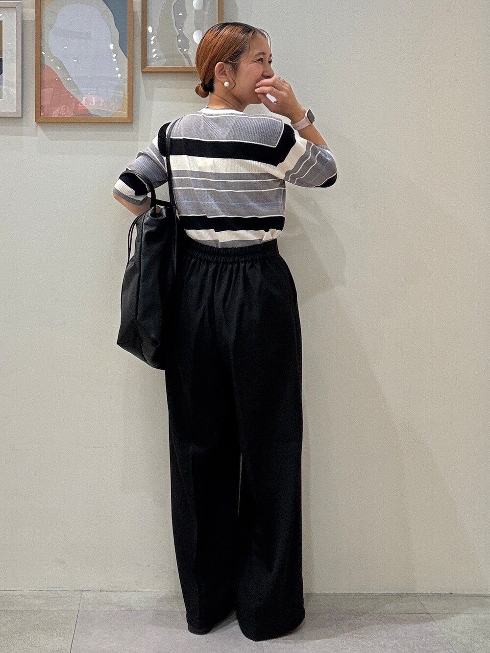 グレー系のニット/セーター、ブラック系のその他パンツ、ブラック系のトートバッグを着用したレディースの夏コーディネートの3枚目の写真
