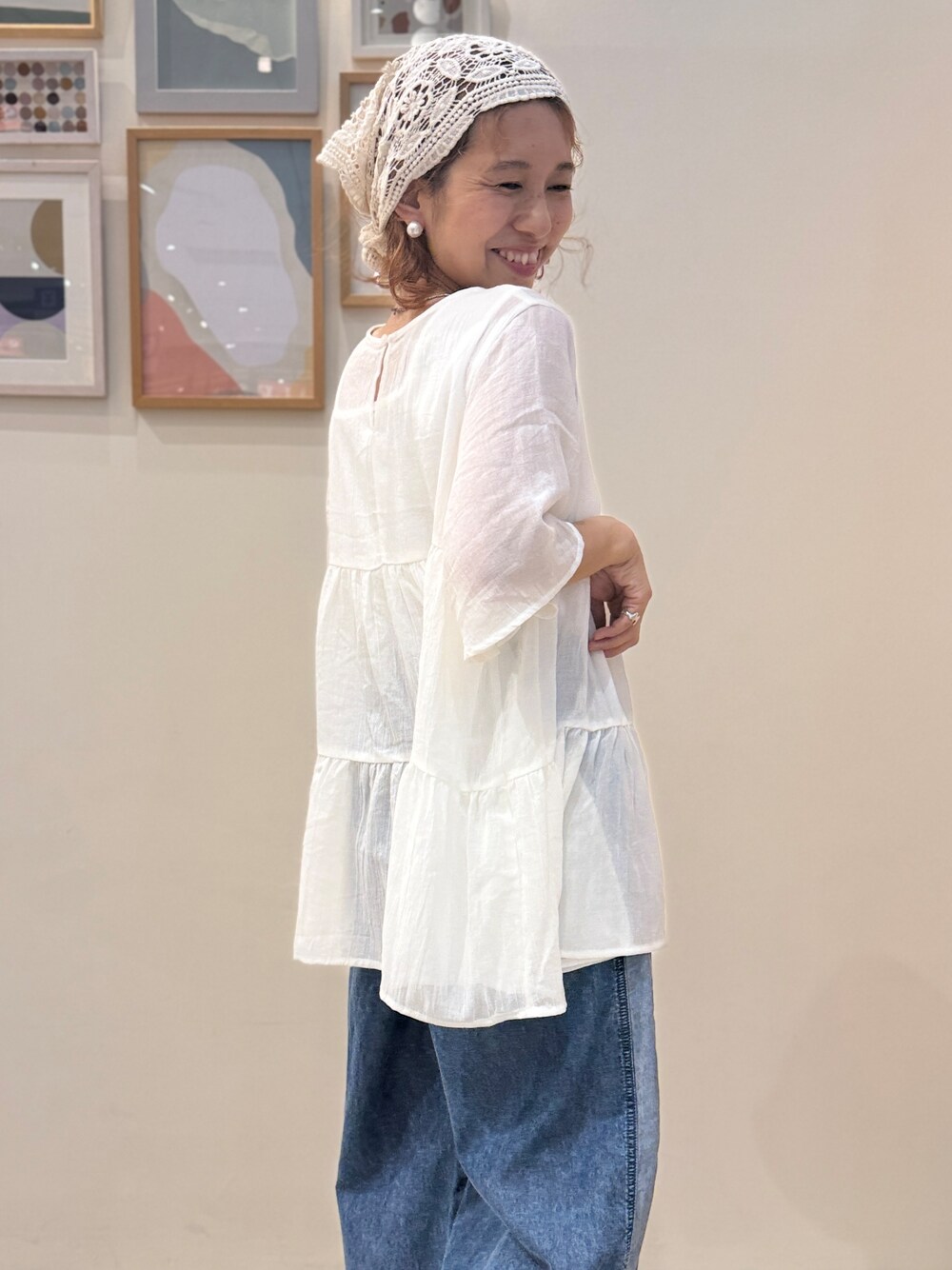 ブルー系のデニムパンツ、ブラック系のサンダルを着用したレディースの夏コーディネートの5枚目の写真