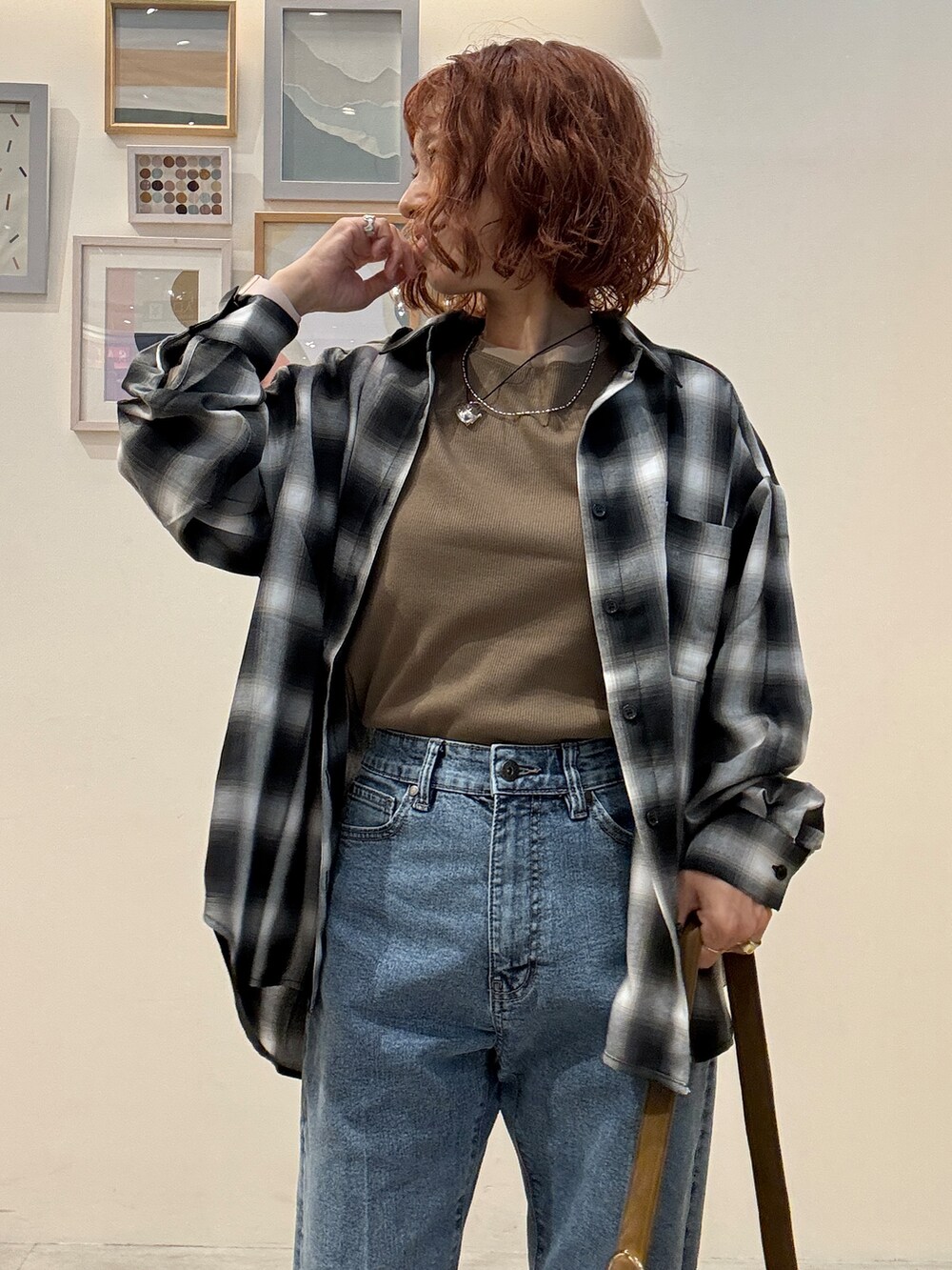 グレー系のシャツ/ブラウス、イエロー系のTシャツ/カットソー、ブルー系のデニムパンツを着用したレディースの秋コーディネートの5枚目の写真