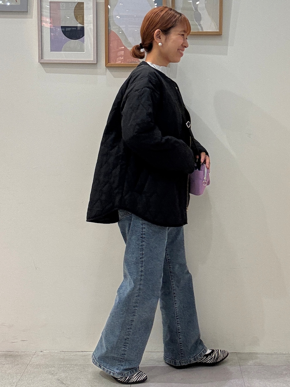シルバー系のニット/セーター、ブルー系のデニムパンツ、ブラック系のパンプスを着用したレディースの秋コーディネートの2枚目の写真