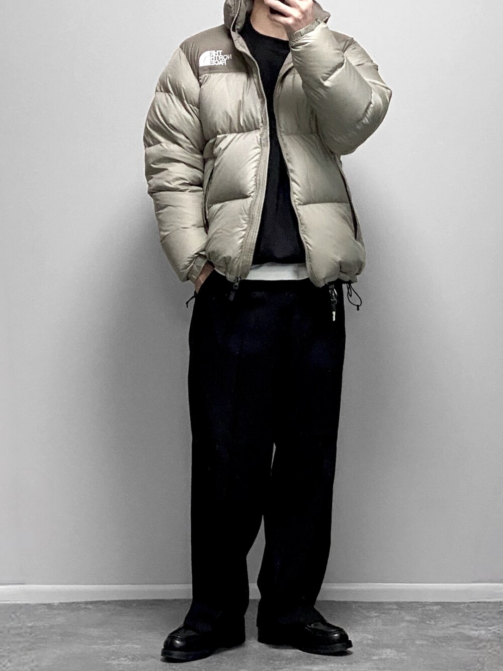 ブルー系のダウンジャケット/コート、ブルー系のデニムパンツ、ブラック系のスニーカーを着用したメンズの冬コーディネートの2枚目の写真