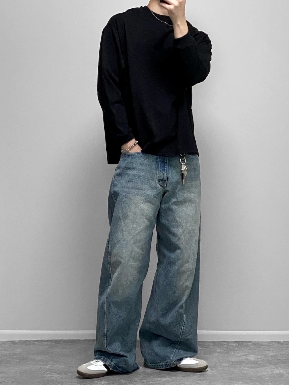 レッド系のスウェット、ホワイト系のタンクトップ、ブラック系のスラックスを着用したメンズの秋コーディネートの2枚目の写真