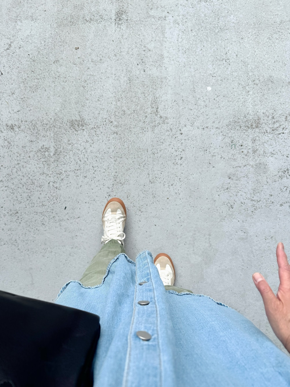 ホワイト系のシューズ、グリーン系のパンツ、ブラック系のボストンバッグを着用したレディースの秋コーディネートの2枚目の写真