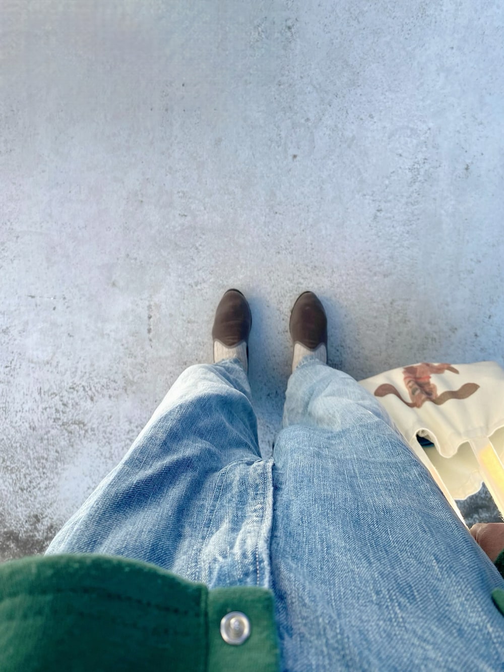 グレー系のスリッポン、ホワイト系のバッグ、ブルー系のサロペット/オーバーオールを着用したレディースの冬コーディネートの2枚目の写真