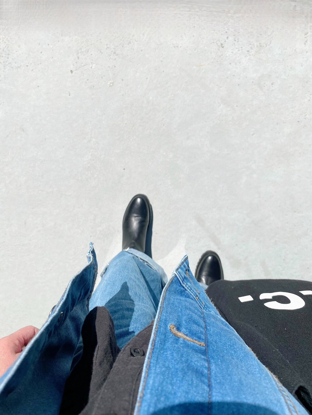 ブラック系のシューズ、ブルー系のパンツ、ブルー系のトートバッグを着用したレディースの春コーディネートの2枚目の写真