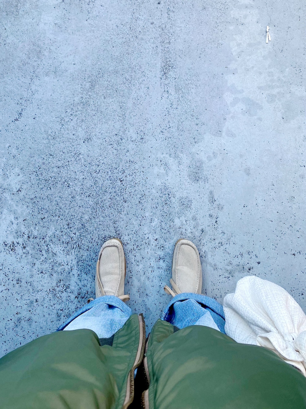 ベージュ系のシューズ、ブルー系のデニムパンツ、ホワイト系のバッグを着用したレディースの冬コーディネートの2枚目の写真