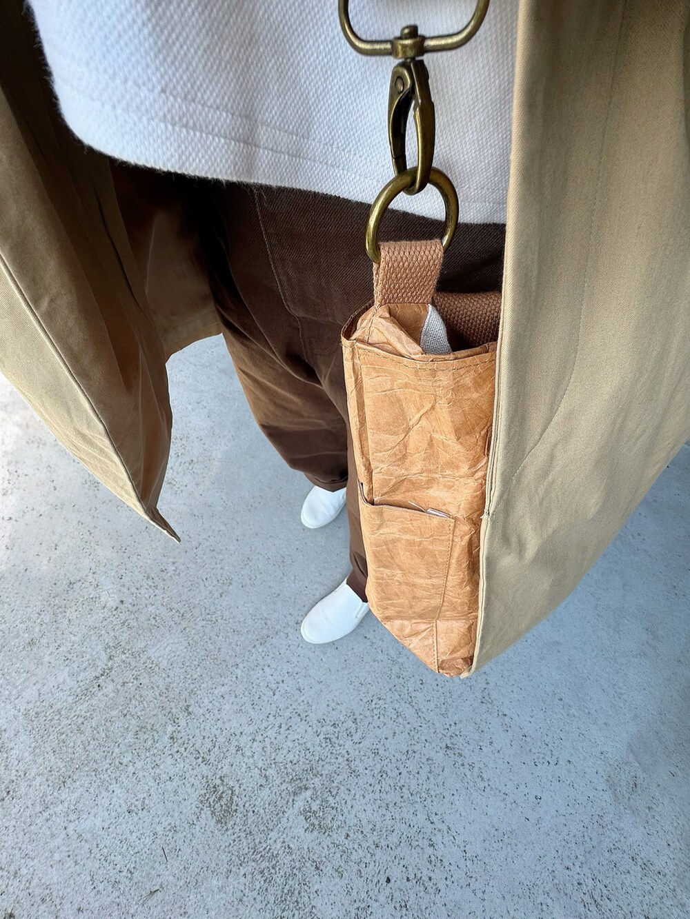 ブラウン系のパンツ、ベージュ系のバッグ、ベージュ系のジャケット/アウターを着用したレディースの春コーディネートの2枚目の写真