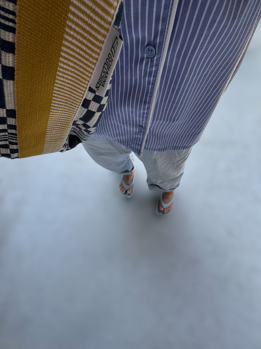 ブルー系のシューズ、ブルー系のパンツ、ブルー系のバッグを着用したレディースの夏コーディネートの2枚目の写真