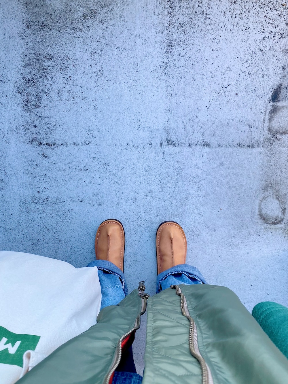 ベージュ系のシューズ、ブルー系のオールインワン・サロペット、ホワイト系のバッグを着用したレディースの冬コーディネートの3枚目の写真