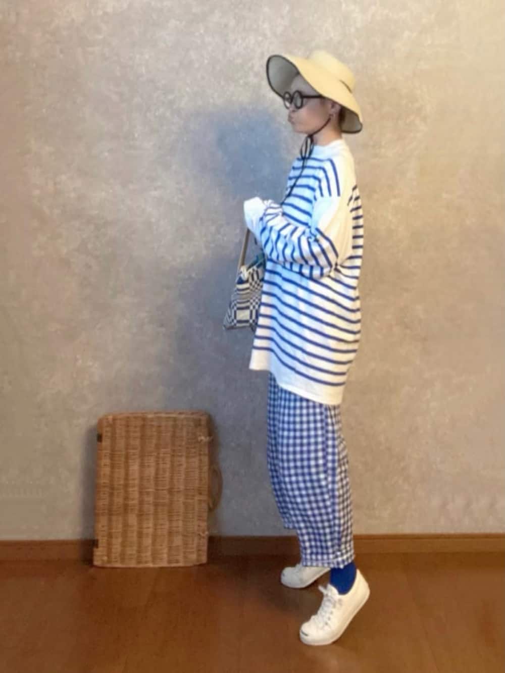 ホワイト系のスニーカー、ブルー系のパンツ、ブルー系のバッグを着用したレディースの夏コーディネートの2枚目の写真
