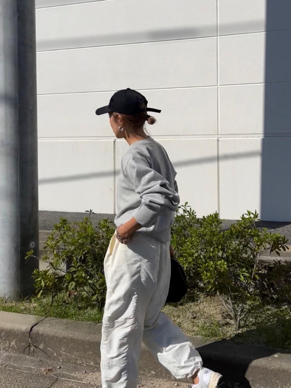 グレー系のスウェット、ホワイト系のその他パンツを着用したレディースの秋コーディネートの2枚目の写真