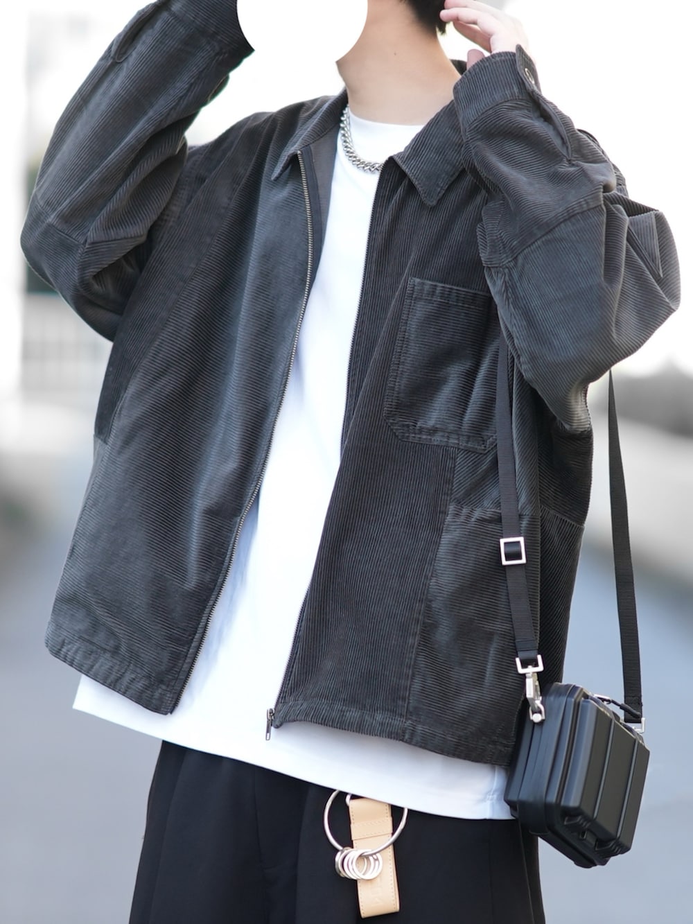 グレー系のブルゾン、ホワイト系のTシャツ/カットソー、ブラック系のカーゴパンツを着用したメンズの秋コーディネートの2枚目の写真