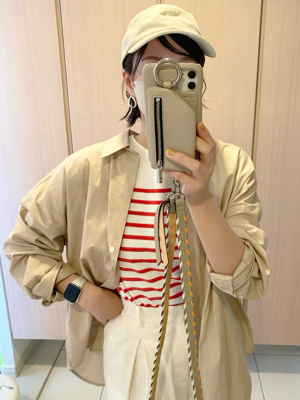 レッド系のトップス、ベージュ系のシャツ/ブラウス、ホワイト系のその他パンツを着用したレディースの春コーディネートの2枚目の写真