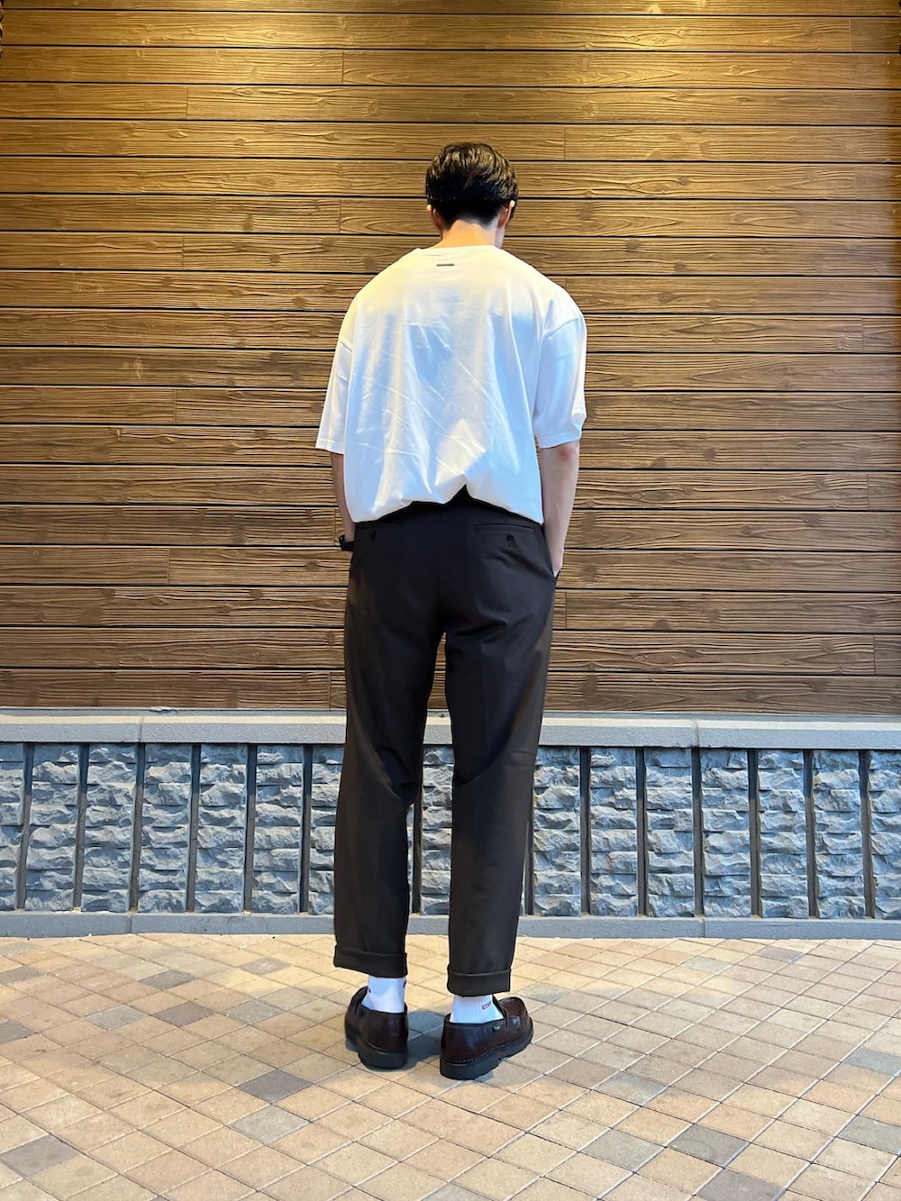 ホワイト系のTシャツ/カットソー、ブラウン系のスラックス、ブラウン系のローファーを着用したメンズの夏コーディネートの4枚目の写真