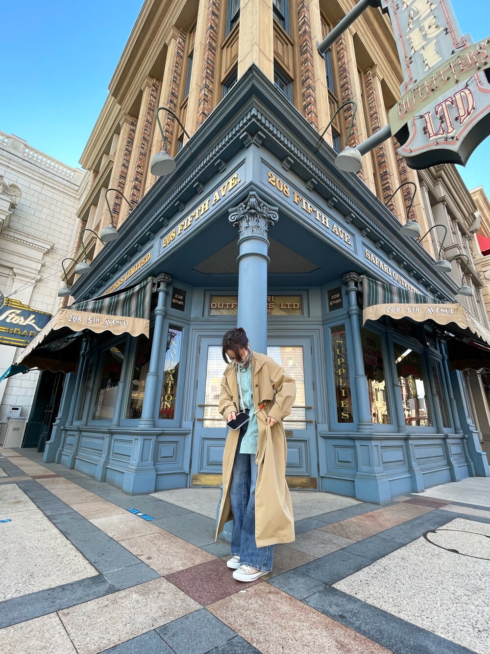 ブルー系のデニムパンツ、グリーン系のシャツ/ブラウス、ベージュ系のトレンチコートを着用したレディースの冬コーディネートの2枚目の写真