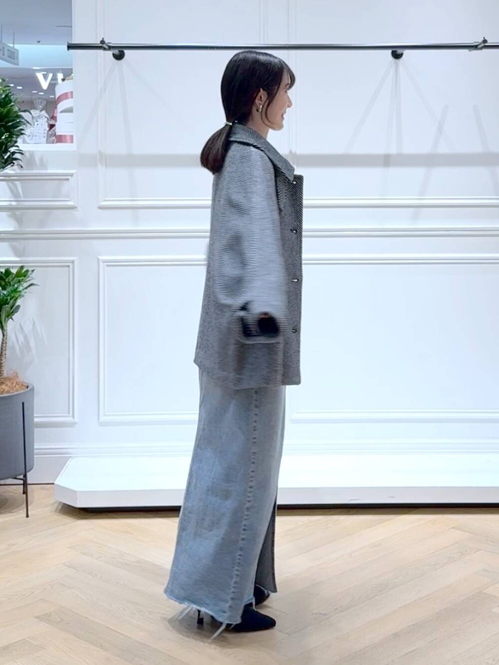 ホワイト系のニット/セーター、ブルー系のデニムスカート、ブラック系のブーツを着用したレディースの秋コーディネートの3枚目の写真