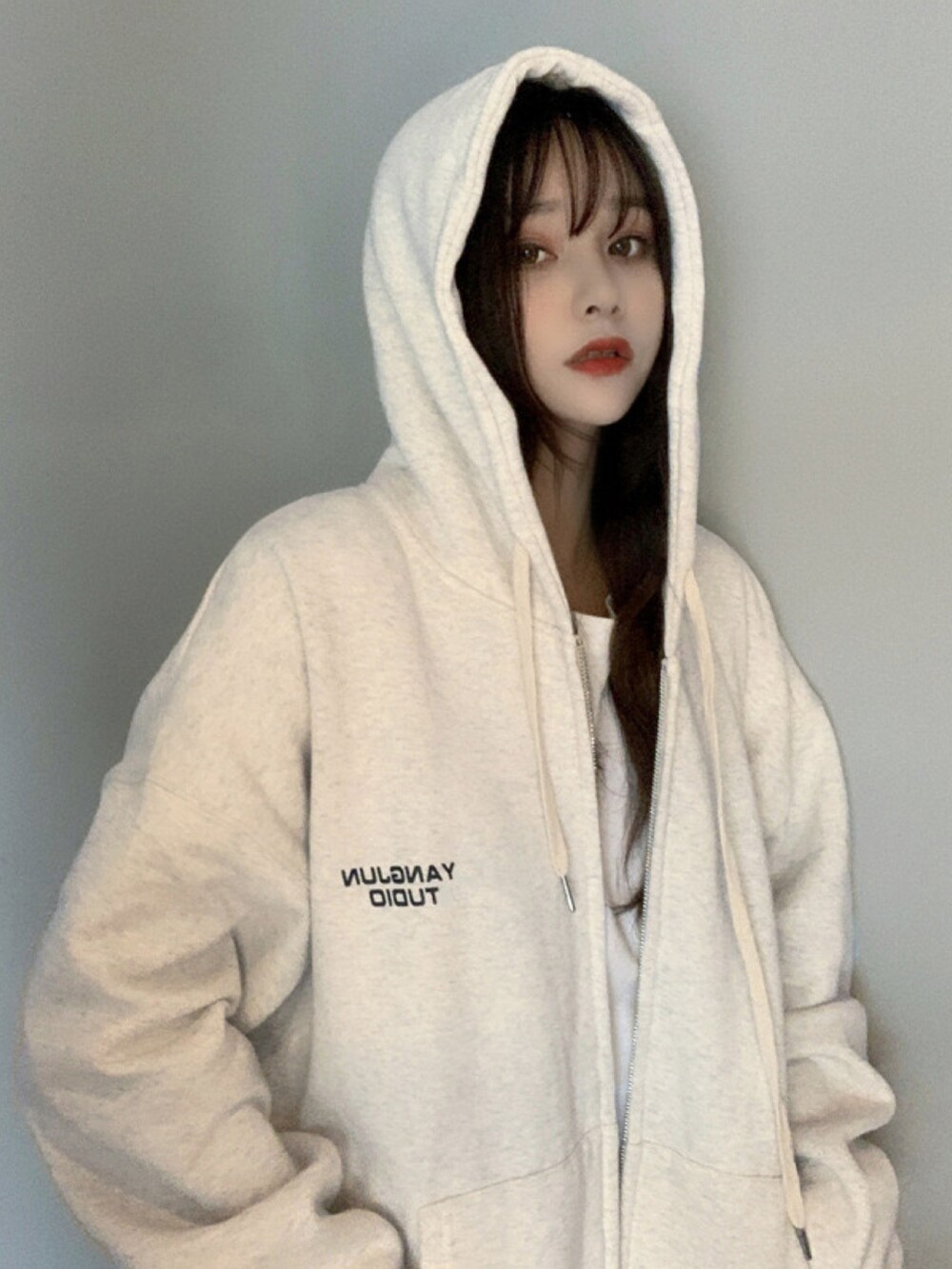 ベージュ系のパーカーを着用したレディースの冬コーディネートの3枚目の写真