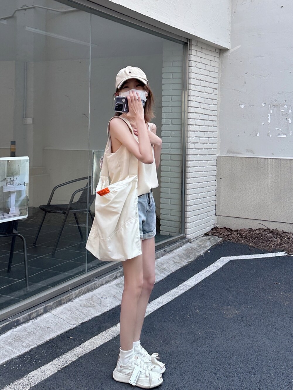 ベージュ系のショルダーバッグを着用したレディースの冬コーディネートの2枚目の写真