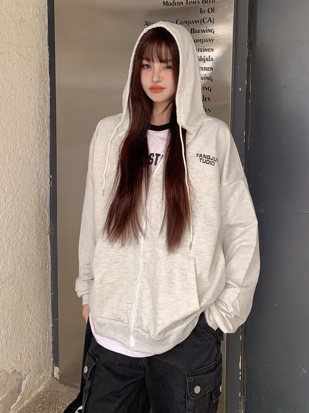 ベージュ系のパーカーを着用したレディースの冬コーディネートの3枚目の写真