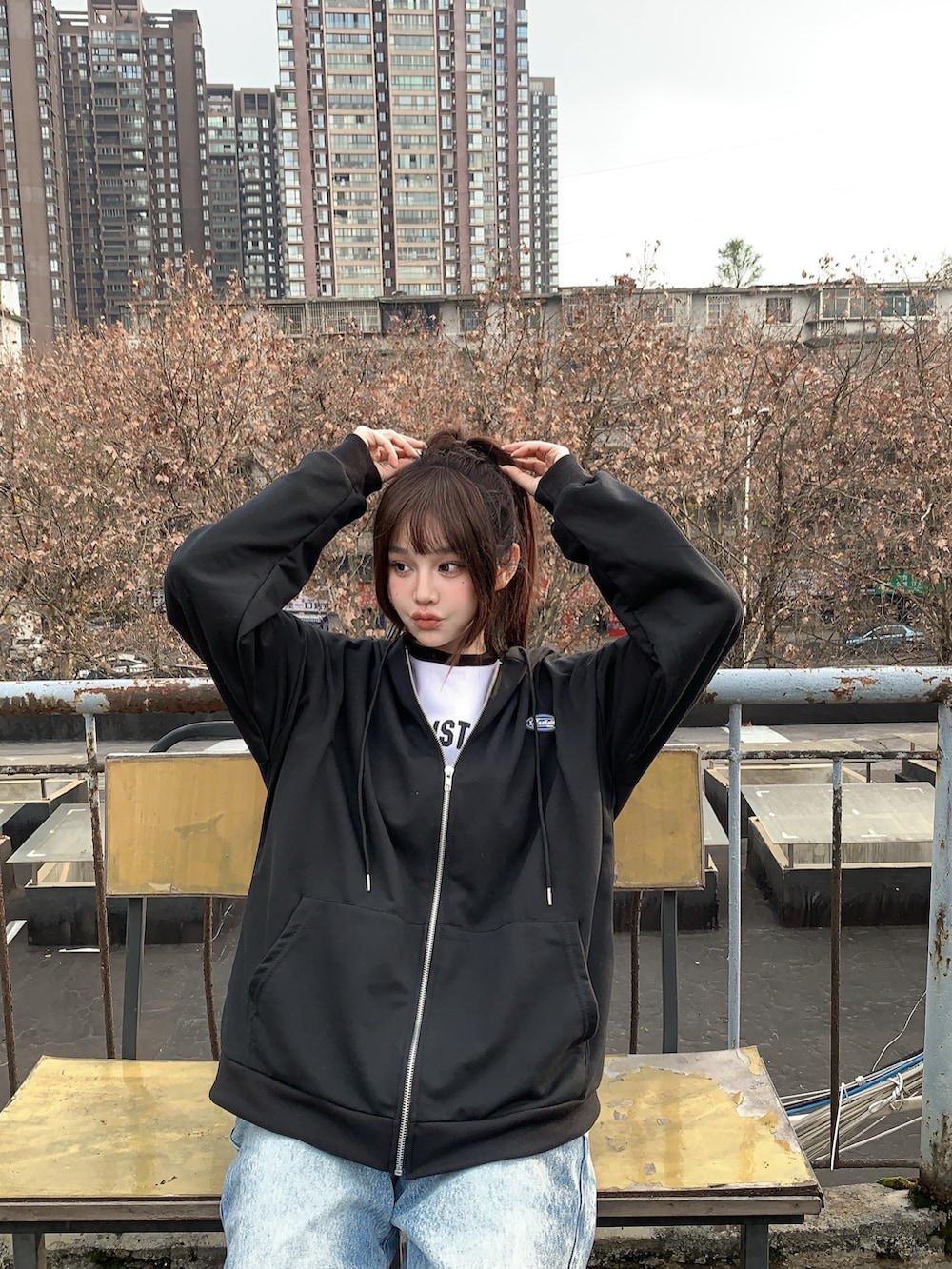 ブラック系のパーカーを着用したレディースの冬コーディネートの2枚目の写真