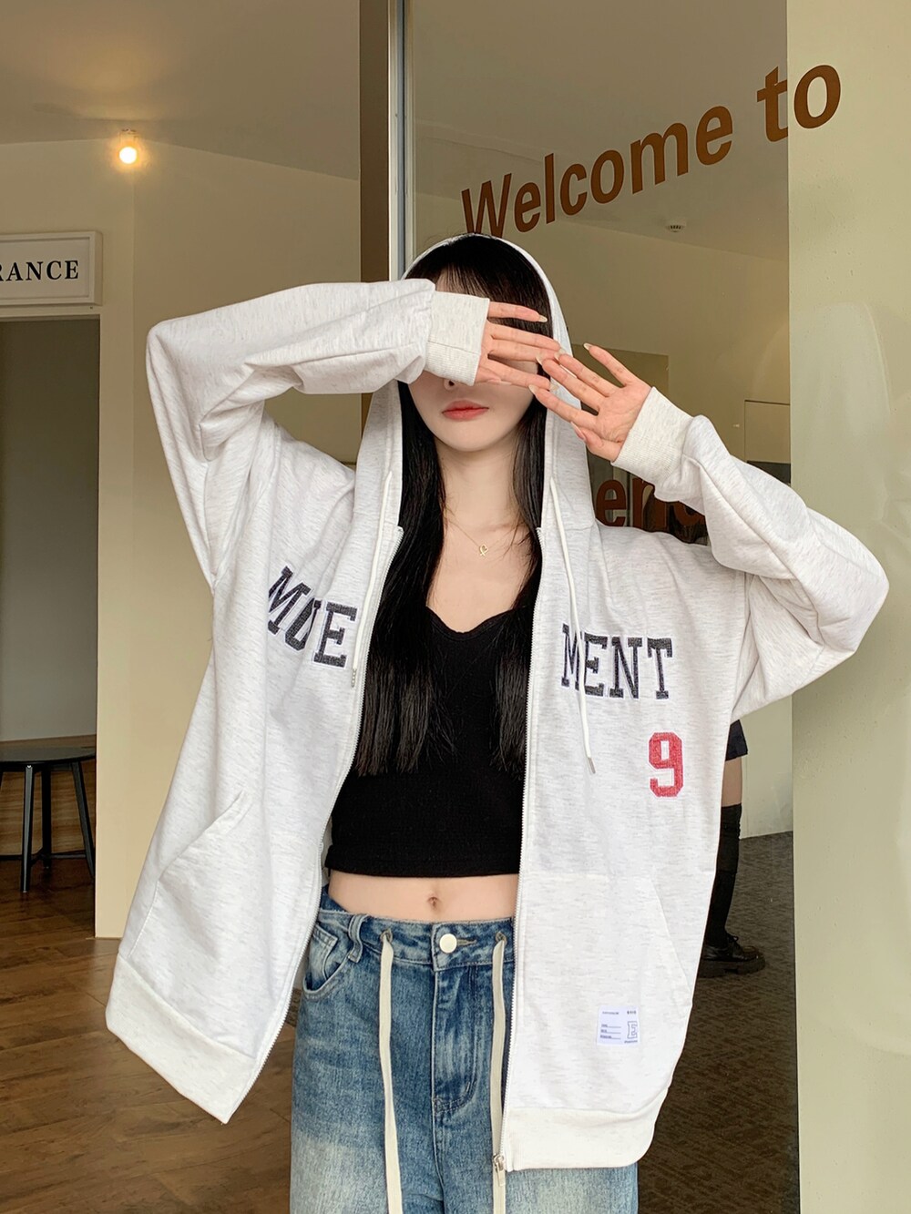 グレー系のパーカーを着用したレディースの春コーディネートの2枚目の写真