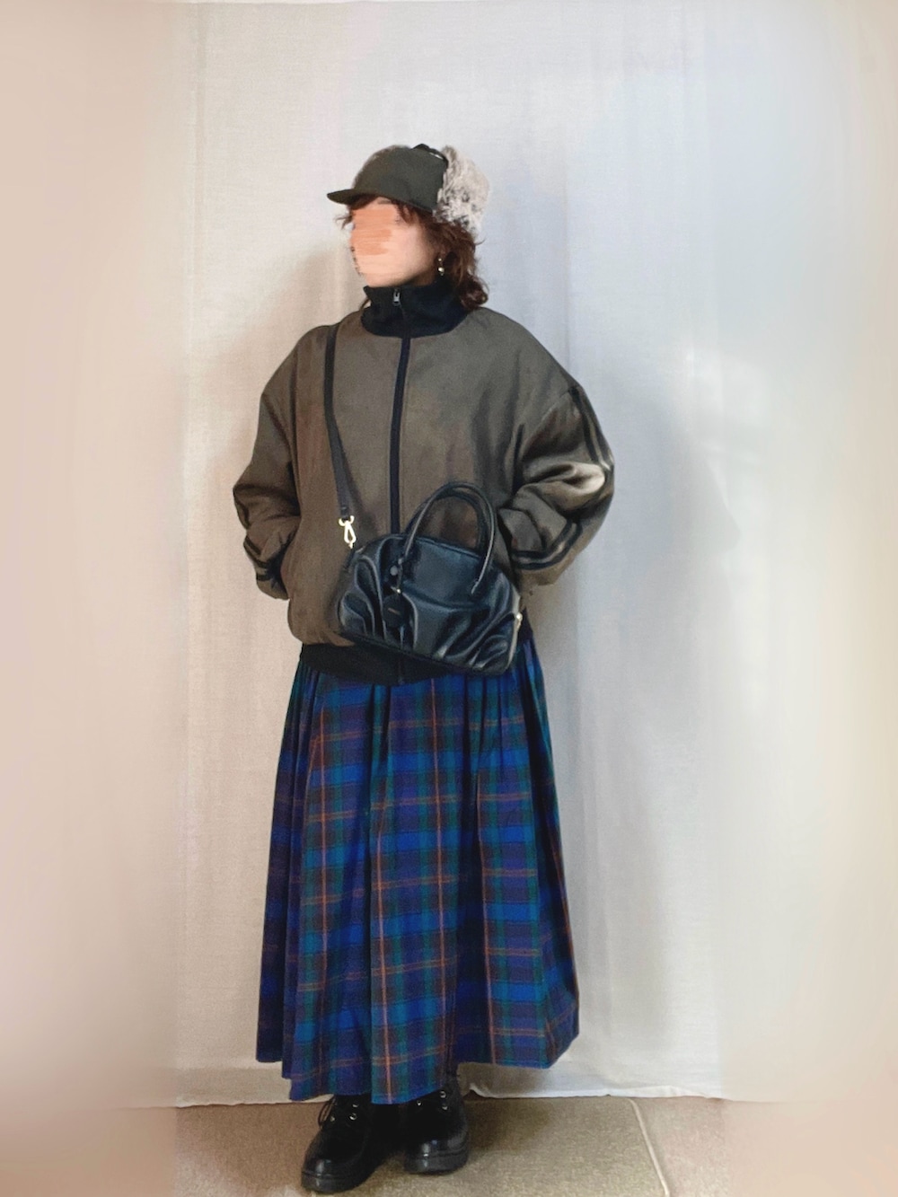 グリーン系のジャージ、ブルー系のスカート、ブラック系のローファーを着用したレディースの春コーディネートの2枚目の写真