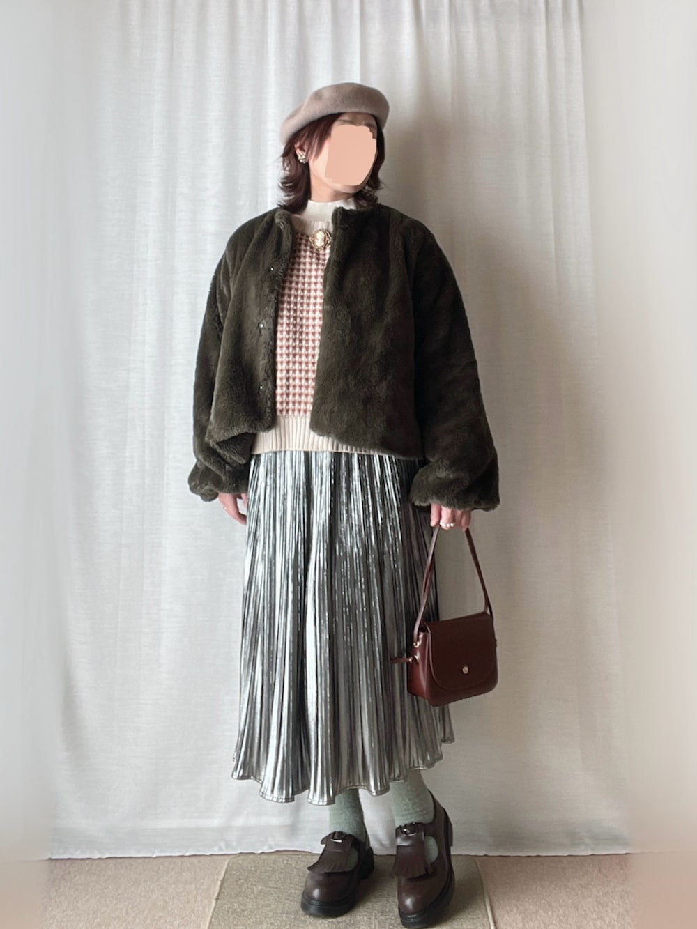 レッド系のカーディガン/ボレロ、ベージュ系のニット/セーター、シルバー系のスカートを着用したレディースの冬コーディネートの2枚目の写真